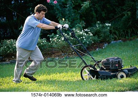 Mid adult man mowing the lawn with a lawn mower View Large Photo Image Stock Image - Mid adult man mowing the lawn with a lawn mower. Fotosearch