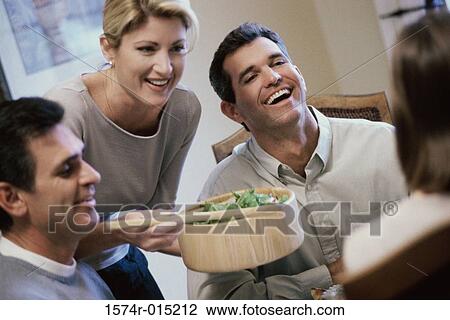 Mid adult woman serving salad View Large Photo Image Stock Image - Mid adult woman serving salad. Fotosearch