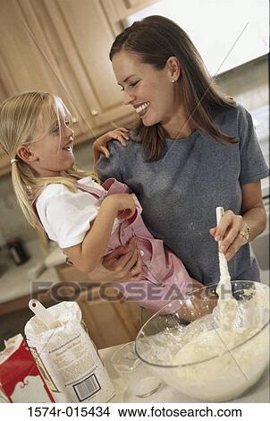 Picture - Mother and daughter preparing food in the kitchen. Fotosearch