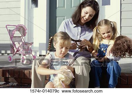 Mother braiding her daughter's hair View Large Photo Image Stock Image - Mother braiding her daughter's hair. Fotosearch