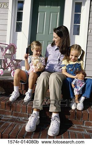 Mother sitting with her two daughters on steps View Large Photo Image Stock Image - Mother sitting with her two daughters on steps. Fotosearch