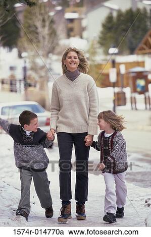 Mother walking with her two children View Large Photo Image Stock Image - Mother walking with her two children. Fotosearch