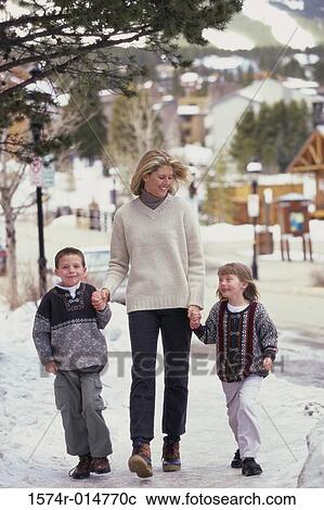 Stock Image - Mother walking with her two children. Fotosearch