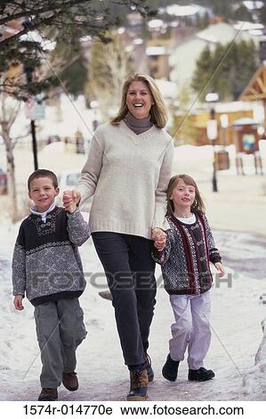 Mother walking with her two children View Large Photo Image Stock Image - Mother walking with her two children. Fotosearch