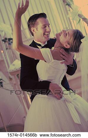 Stock Image - Newlywed couple dancing. Fotosearch