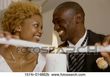 Newlywed couple lighting candles View Large Photo Image Stock Image - Newlywed couple lighting candles. Fotosearch