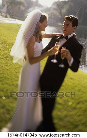 Newlywed couple toasting with champagne View Large Photo Image Stock Image - Newlywed couple toasting with champagne. Fotosearch