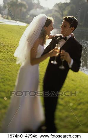 Newlywed couple toasting with champagne View Large Photo Image Stock Image - Newlywed couple toasting with champagne. Fotosearch