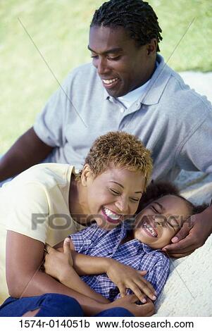 Parents and their daughter smiling View Large Photo Image Stock Image - Parents and their daughter smiling. Fotosearch