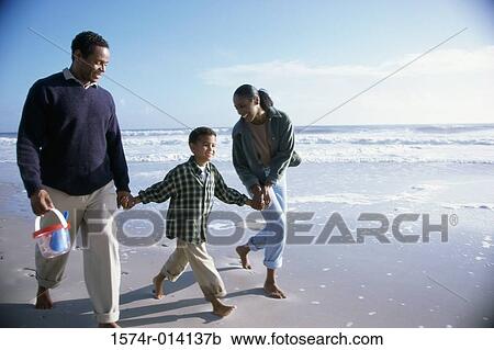 Parents and their son walking on the beach View Large Photo Image Stock Image - Parents and their son walking on the beach. Fotosearch