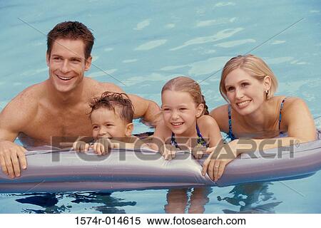 Parents and their two children in a swimming pool View Large Photo Image Stock Photography - Parents and their two children in a swimming pool. Fotosearch