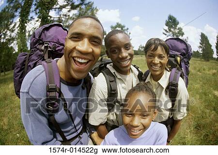 Stock Image - Parents hiking with their son and daughter. Fotosearch