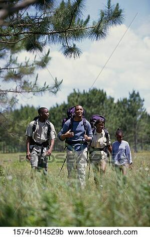 Stock Image - Parents hiking with their son and daughter. Fotosearch