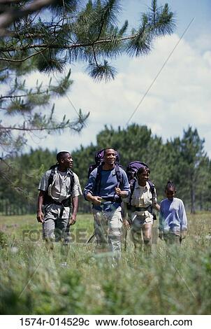 Stock Image - Parents hiking with their son and daughter. Fotosearch