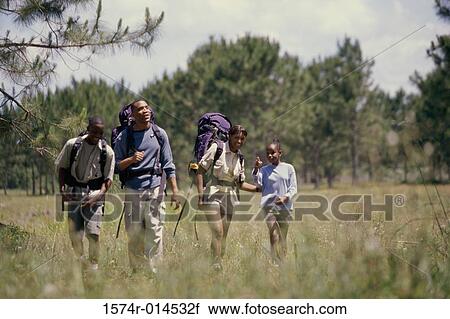 Parents hiking with their son and daughter in a field View Large Photo Image Stock Image - Parents hiking with their son and daughter in a field. Fotosearch