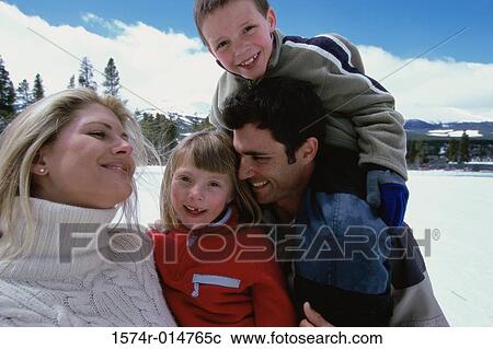 Stock Image - Parents laughing with their son and daughter. Fotosearch
