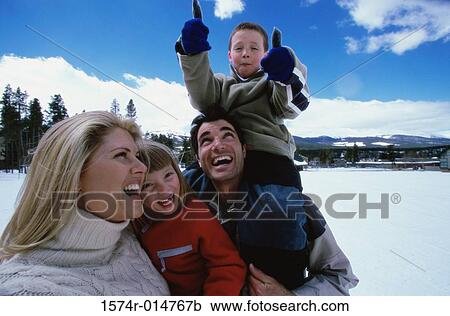 Stock Image - Parents laughing with their son and daughter. Fotosearch