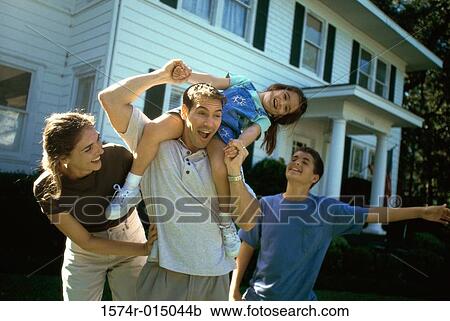 Stock Image - Parents playing with their son and daughter. Fotosearch