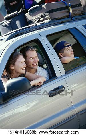 Stock Image - Parents sitting in a car with their son. Fotosearch