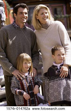Stock Image - Parents standing with their son and daughter. Fotosearch