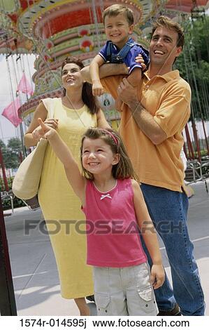 Parents with their son and daughter at an amusement park View Large Photo Image Stock Image - Parents with their son and daughter at an amusement park. Fotosearch