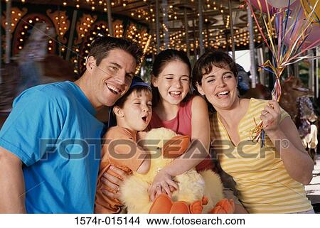 Parents with their son and daughter in an amusement park View Large Photo Image Picture - Parents with their son and daughter in an amusement park. Fotosearch