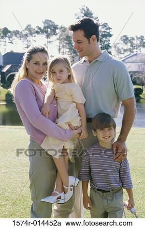 Parents with their son and daughter smiling View Large Photo Image Stock Image - Parents with their son and daughter smiling. Fotosearch