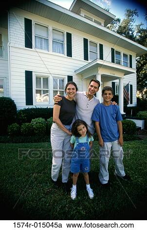 Parents with their son and daughter standing in front of a house View Large Photo Image Stock Image - Parents with their son and daughter standing in front of a house. Fotosearch