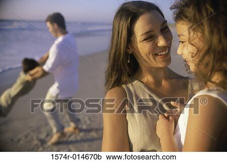 Parents with their two children on the beach View Large Photo Image Stock Image - Parents with their two children on the beach. Fotosearch