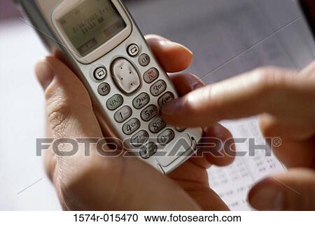 Person operating a mobile phone View Large Photo Image Stock Image - Person operating a mobile phone. Fotosearch