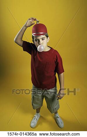 Portrait of a boy wearing a beanie and blowing a bubble View Large Photo Image Stock Image - Portrait of a boy wearing a beanie and blowing a bubble. Fotosearch