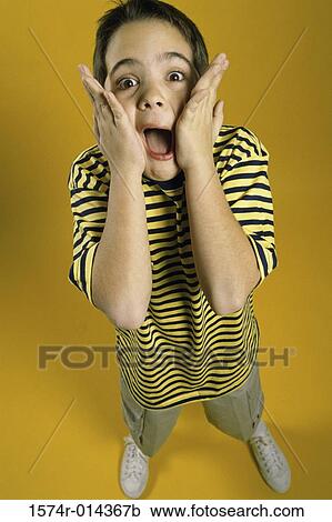 Portrait of a boy with his hands on his cheeks View Large Photo Image Stock Image - Portrait of a boy with his hands on his cheeks. Fotosearch