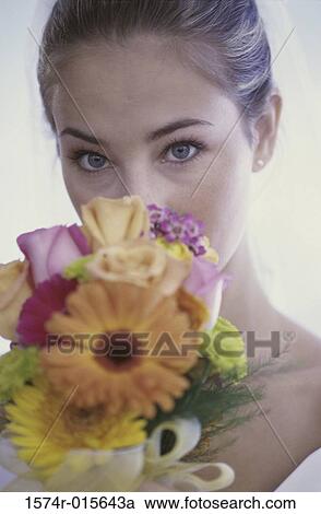 Stock Image - Portrait of a bride holding a bouquet of flowers. Fotosearch