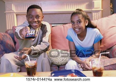 Portrait of a brother and sister watching television View Large Photo Image Stock Image - Portrait of a brother and sister watching television. Fotosearch