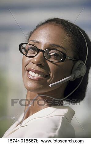 Portrait of a businesswoman wearing a headset View Large Photo Image Stock Image - Portrait of a businesswoman wearing a headset. Fotosearch
