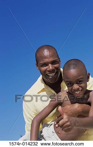 Portrait of a father and son smiling View Large Photo Image Stock Image - Portrait of a father and son smiling. Fotosearch