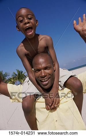Portrait of a father carrying his son on his shoulders View Large Photo Image Stock Image - Portrait of a father carrying his son on his shoulders. Fotosearch