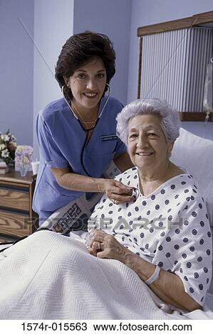 Portrait of a female nurse examining a patient View Large Photo Image Stock Image - Portrait of a female nurse examining a patient. Fotosearch