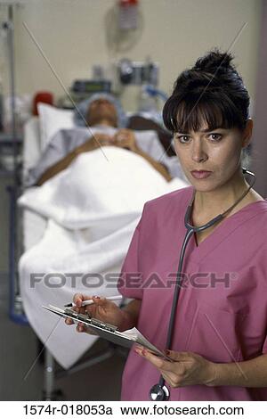 Portrait of a female nurse holding a medical chart View Large Photo Image Stock Image - Portrait of a female nurse holding a medical chart. Fotosearch