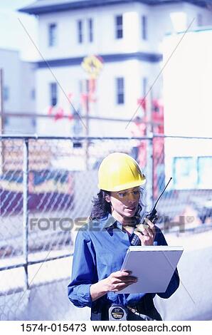 Portrait of a forewoman talking on a walkie-talkie View Large Photo Image Stock Image - Portrait of a forewoman talking on a walkie-talkie. Fotosearch