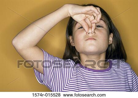 Portrait of a girl holding her nose View Large Photo Image Stock Photo - Portrait of a girl holding her nose. Fotosearch