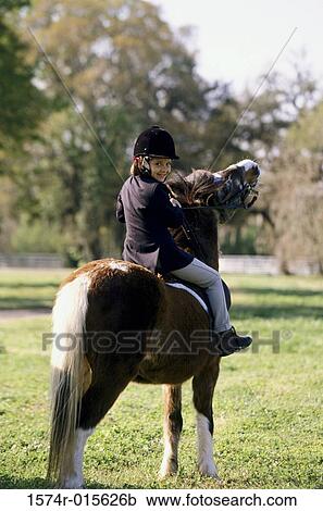 Portrait of a girl riding a horse View Large Photo Image Stock Image - Portrait of a girl riding a horse. Fotosearch