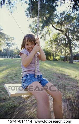 Portrait of a girl swinging on a swing View Large Photo Image Picture - Portrait of a girl swinging on a swing. Fotosearch