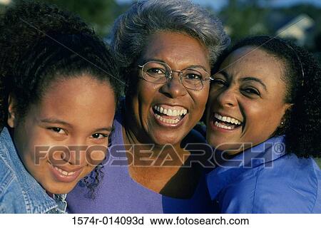 Stock Image - Portrait of a grandmother smiling with her daughter and granddaughter. Fotosearch