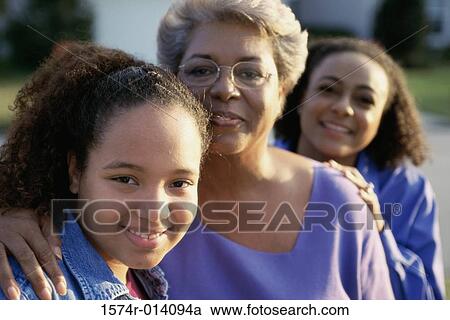 Stock Image - Portrait of a grandmother smiling with her daughter and granddaughter. Fotosearch