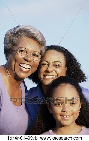 Stock Image - Portrait of a grandmother smiling with her daughter and granddaughter. Fotosearch