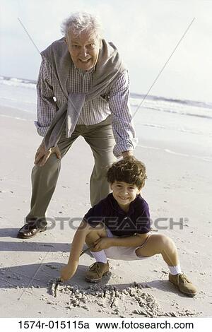 Portrait of a grandson playing with his grandfather on the beach View Large Photo Image Stock Image - Portrait of a grandson playing with his grandfather on the beach. Fotosearch