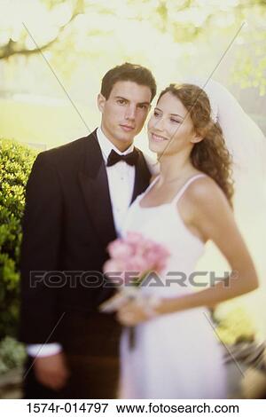 Portrait of a groom standing with his bride View Large Photo Image Stock Photo - Portrait of a groom standing with his bride. Fotosearch