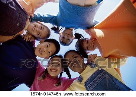 Portrait of a group of children in a huddle View Large Photo Image Stock Image - Portrait of a group of children in a huddle. Fotosearch