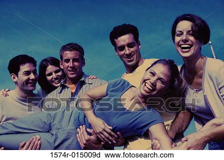 Portrait of a group of young people carrying a young woman View Large Photo Image Stock Image - Portrait of a group of young people carrying a young woman. Fotosearch